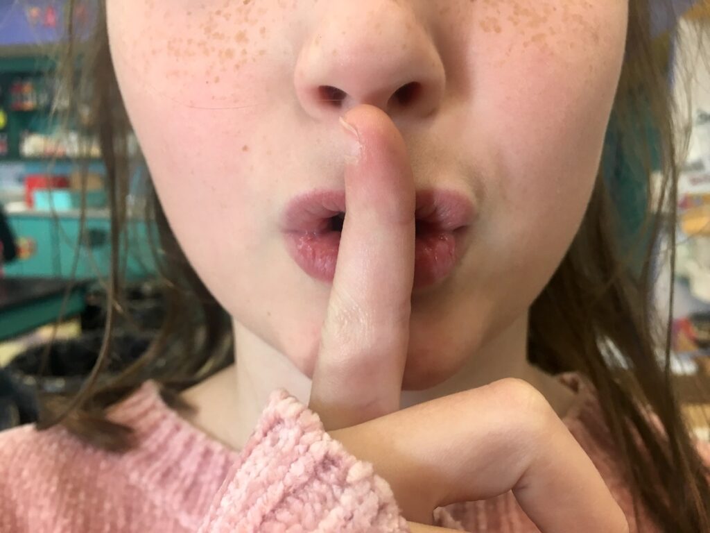 student saying shhhh