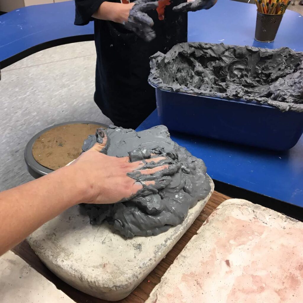 laying clay on a plaster tray
