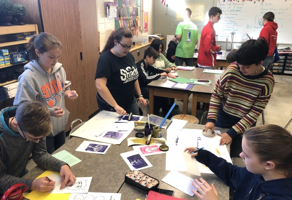 students creating artwork in a classroom