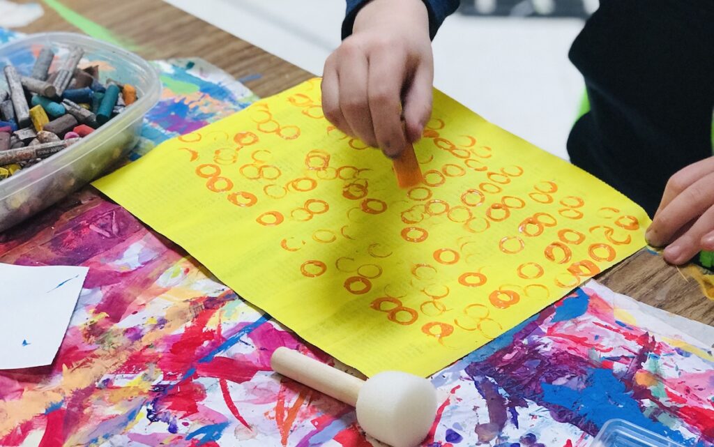 student making marks on paper