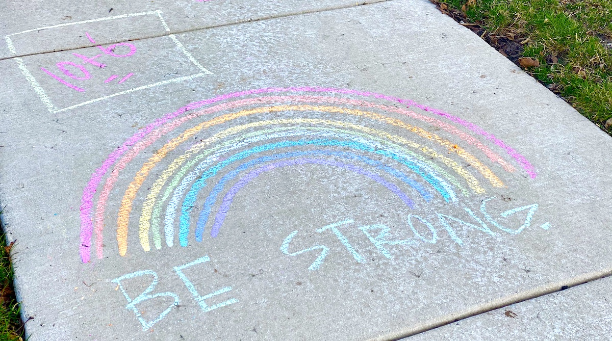 Rainbow drawn on pavement with chalk