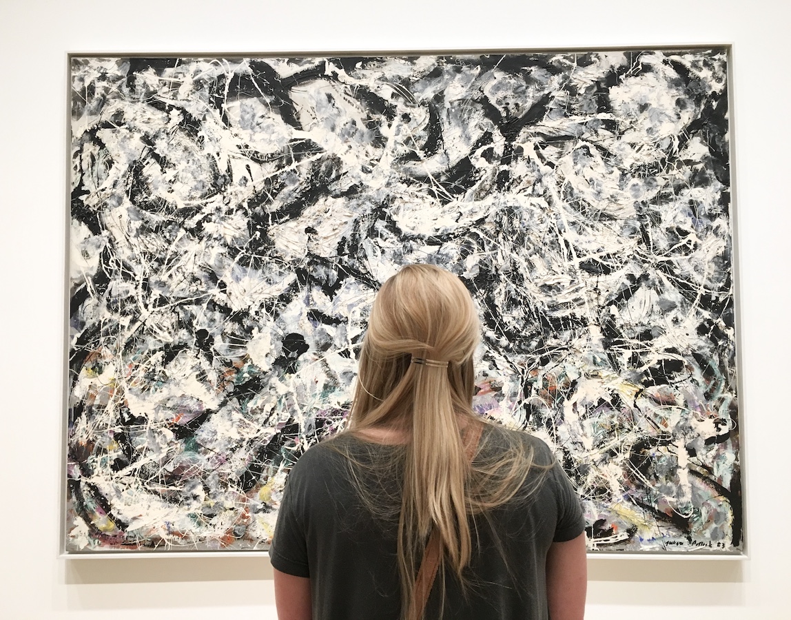 woman looking at Jackson Pollock painting