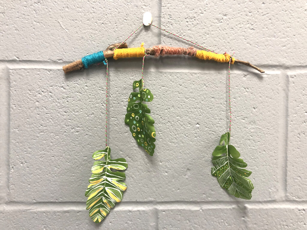 hanging mobile with tree branch and three painted hanging leaves