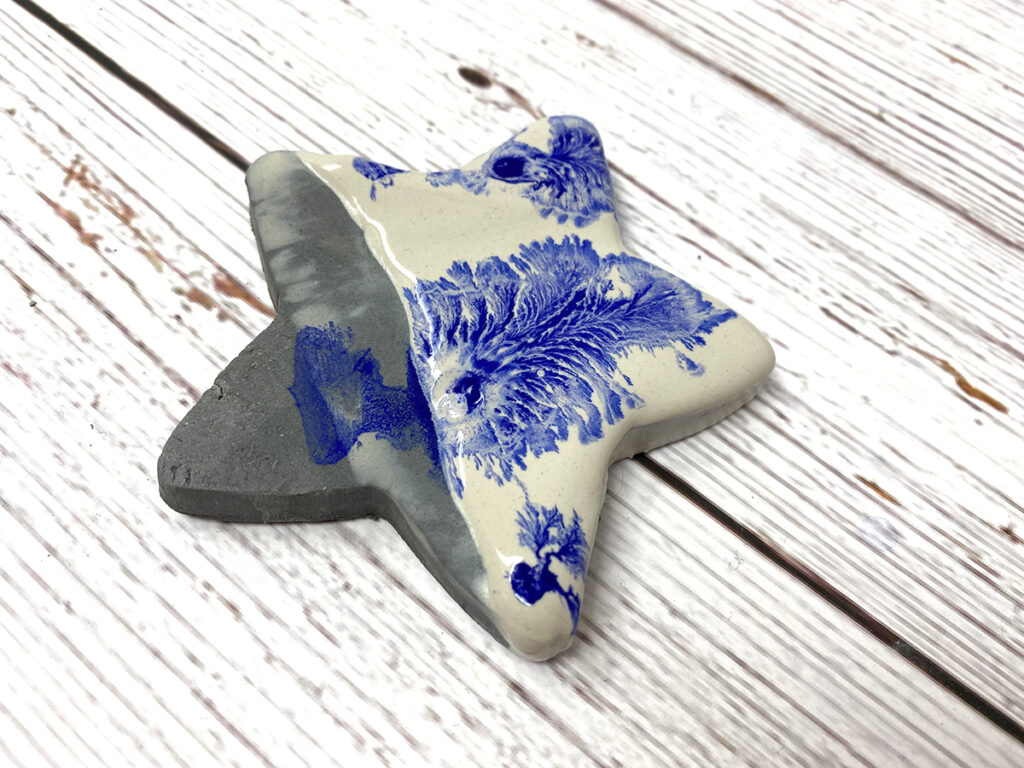 gray ceramic star half glazed with blue and light gray