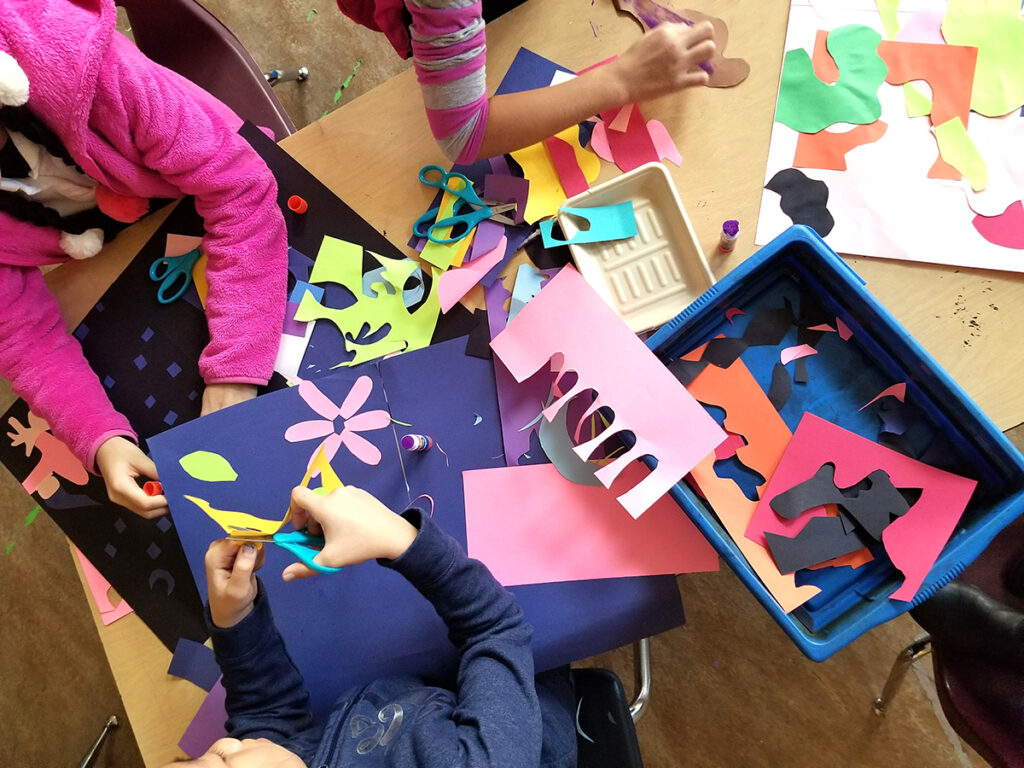 students making paper cutouts