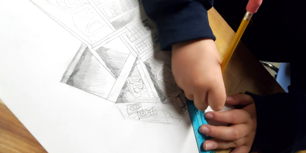 student hands drawing with pencil and ruler