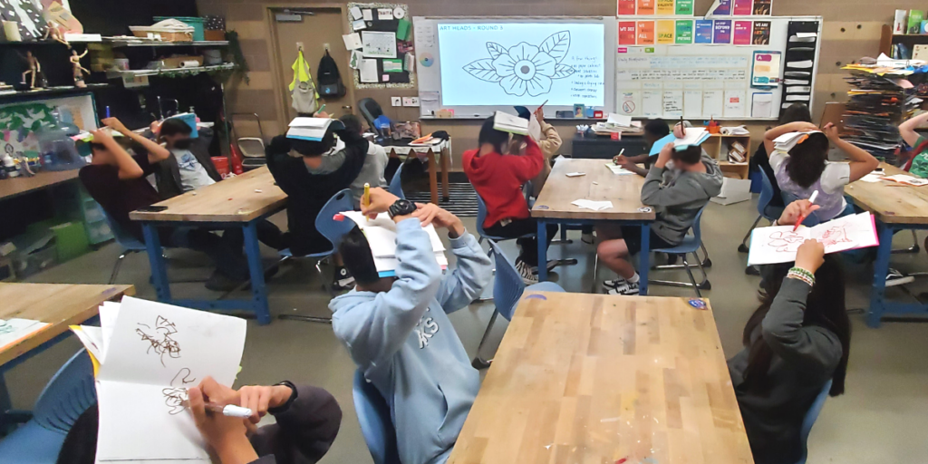 students drawing on their heads