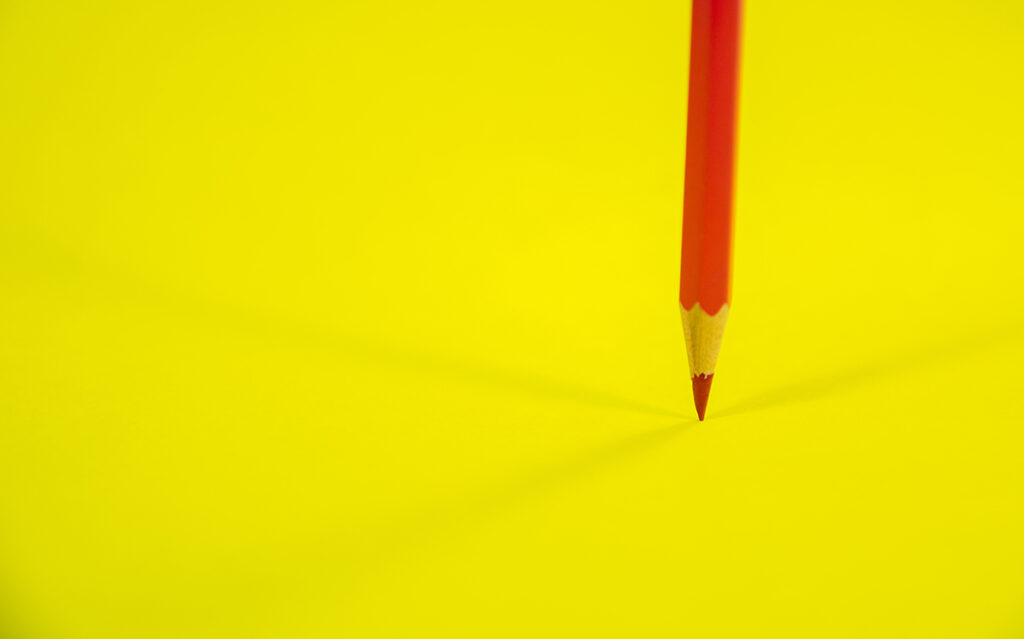 red pencil yellow background