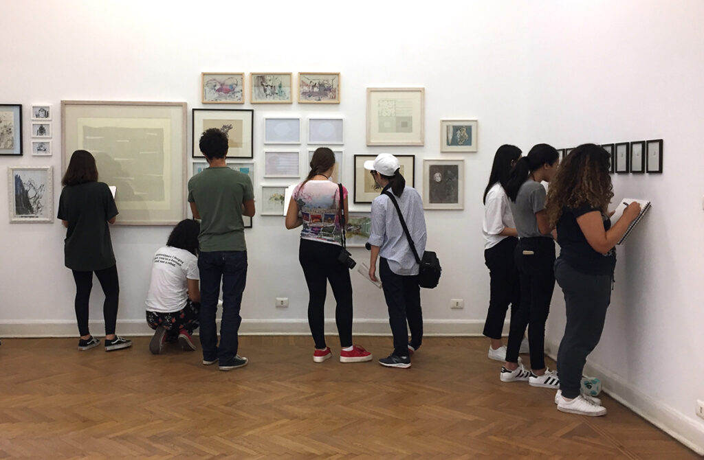 students examining artwork