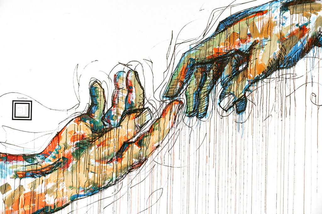 hands reaching artwork