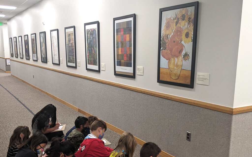 students looking at art in the hall